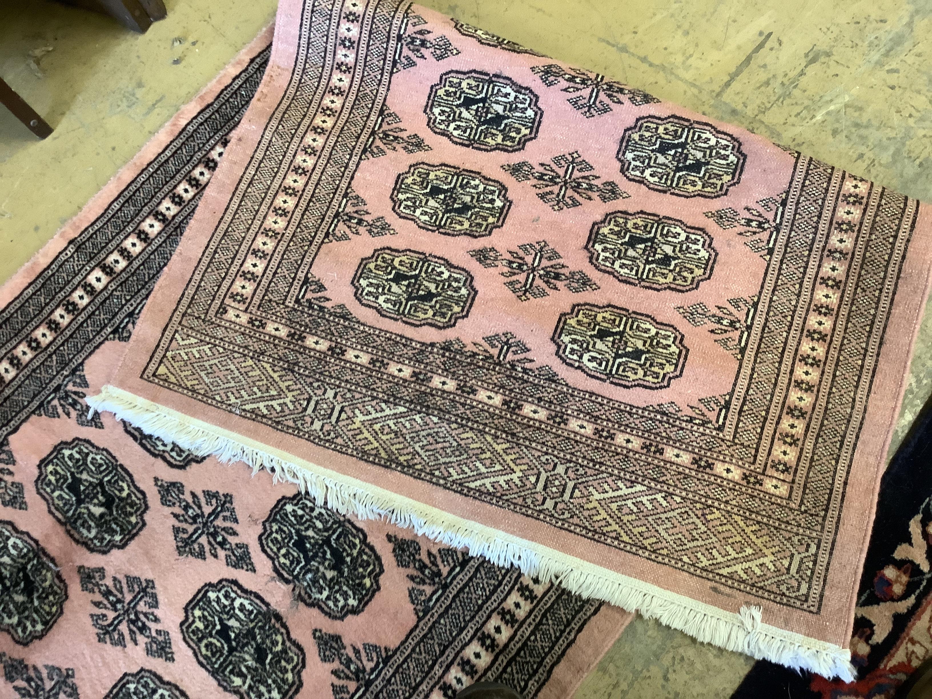 A Bokhara peach ground runner, 310 x 83cm together with a similar rug